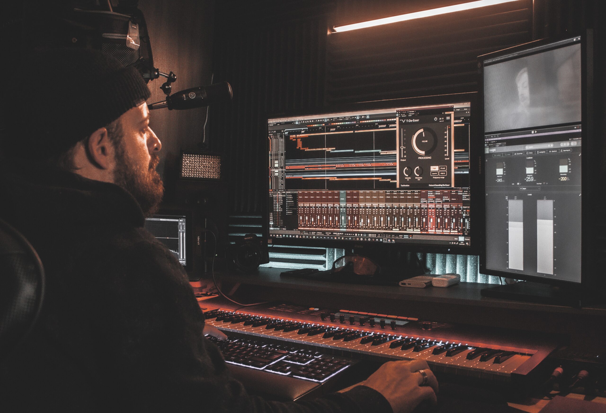 Audio engineer mixing a multitrack session in a professional studio