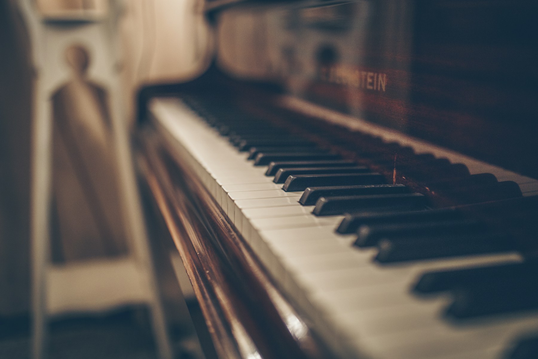 Close-up of hands playing piano keys