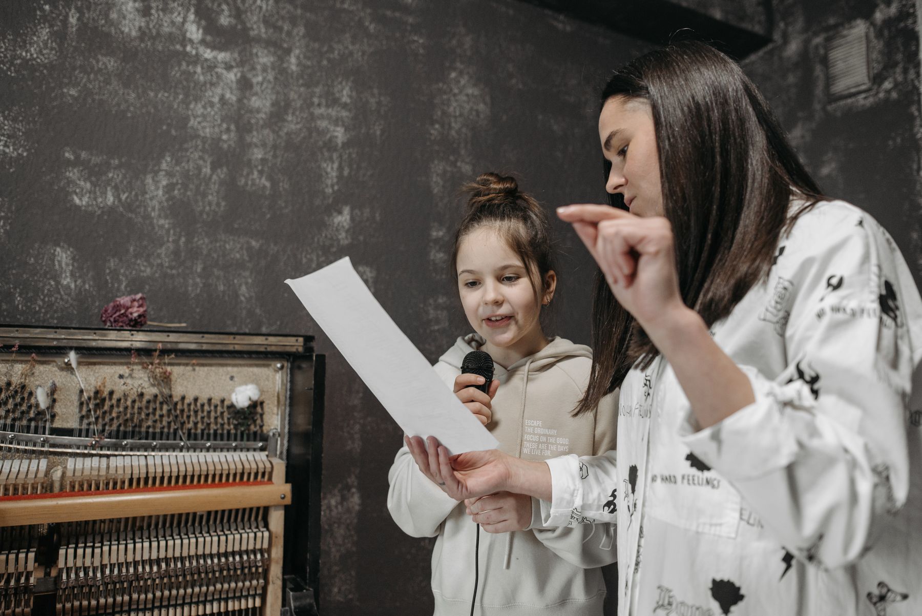 Vocal coach guiding a student during a singing class